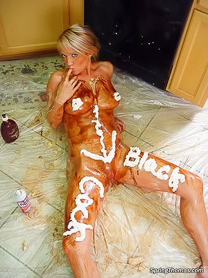 Blonde teen cooking in the kitchen, covering her naked body with cream